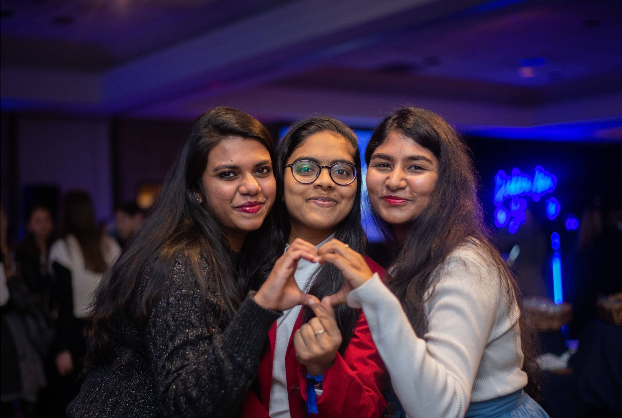 Three graduates pose for a photo at a Toast event